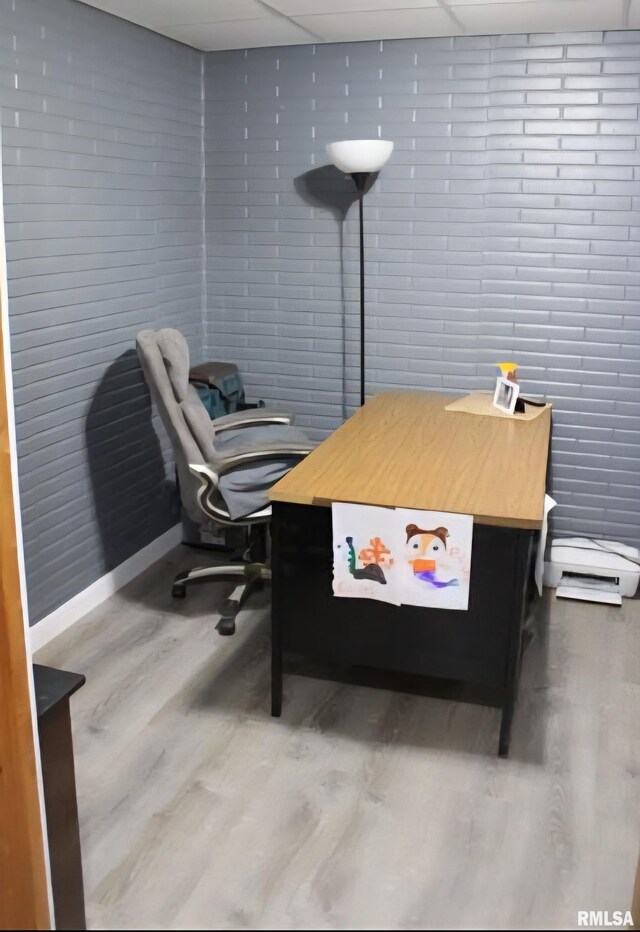 16338 E Red Maple Ln, Lewistown, IL 61542 - office with wood finished floors, a drop ceiling, baseboard heating, baseboards, and brick wall