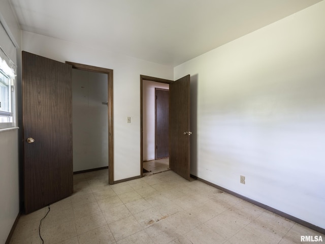 1908 N Idaho St, Peoria, IL 61604 - unfurnished bedroom with light floors, a closet, and a walk in closet