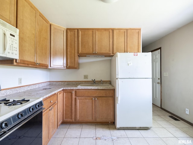 1908 N Idaho St, Peoria, IL 61604 - kitchen with white appliances, light countertops, and light tile patterned floors