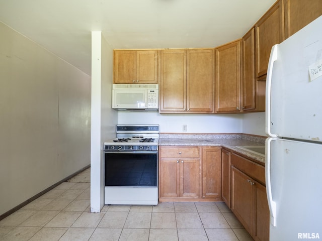 1908 N Idaho St, Peoria, IL 61604 - kitchen featuring white appliances, light tile patterned flooring, light countertops, and brown cabinetry