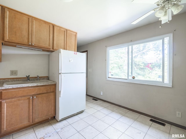 1908 N Idaho St, Peoria, IL 61604 - kitchen featuring freestanding refrigerator, light countertops, ceiling fan, and brown cabinetry