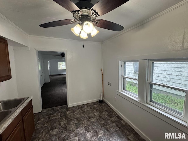 410 E Thrush Ave, Peoria, IL 61603 - unfurnished dining area featuring ornamental molding, ceiling fan, stone finish flooring, baseboards, and a sink
