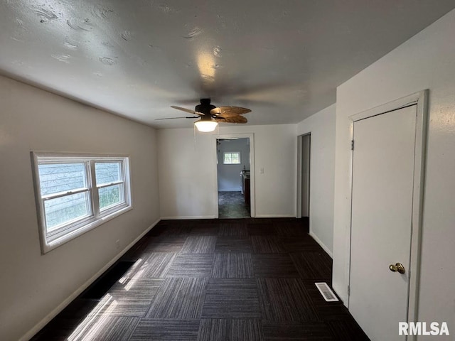 410 E Thrush Ave, Peoria, IL 61603 - empty room featuring plenty of natural light, a ceiling fan, and baseboards
