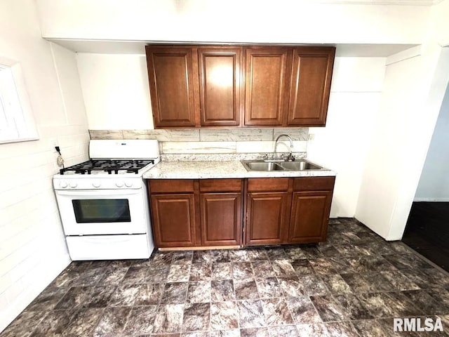 410 E Thrush Ave, Peoria, IL 61603 - kitchen with gas range gas stove, a sink, light countertops, and brown cabinets