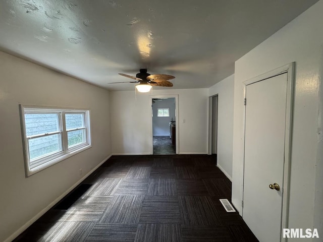 410 E Thrush Ave, Peoria, IL 61603 - unfurnished room with healthy amount of natural light, baseboards, and ceiling fan