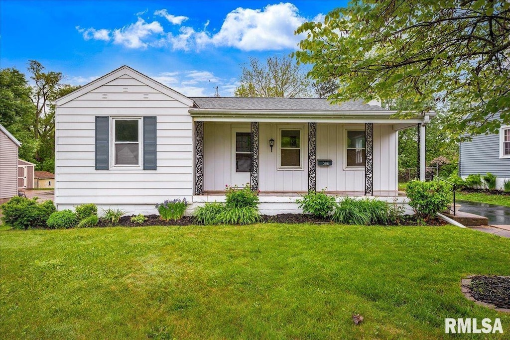 305 Redbud Dr, Washington, IL 61571 - view of front facade featuring covered porch, a front lawn, and board and batten siding