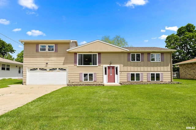 102 Herman St, East Peoria, IL 61611 - bi-level home with an attached garage, a front lawn, driveway, and board and batten siding