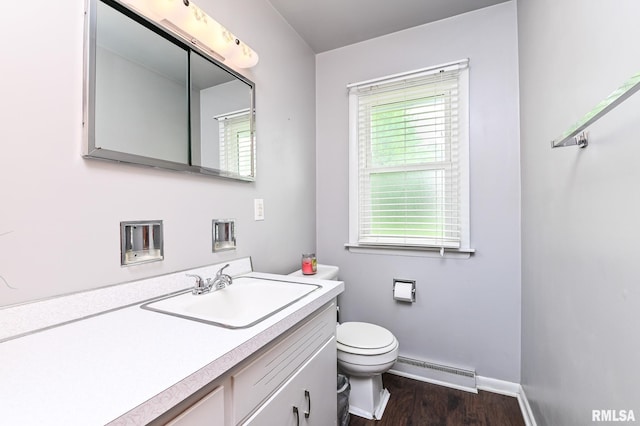 1202 W Purtscher Dr, Peoria, IL 61614 - bathroom featuring a baseboard radiator, vanity, toilet, wood finished floors, and baseboards