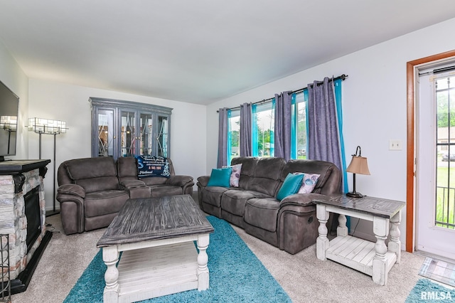 1202 W Purtscher Dr, Peoria, IL 61614 - living area with carpet flooring and a stone fireplace