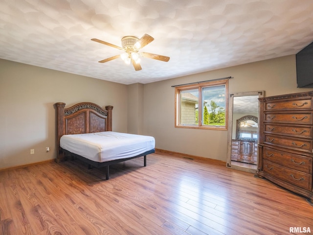26620 Schuck Rd, Washington, IL 61571 - bedroom with baseboards, light wood-type flooring, and a ceiling fan