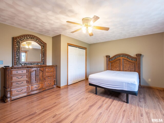 26620 Schuck Rd, Washington, IL 61571 - bedroom with light wood-style flooring, baseboards, a closet, and a ceiling fan