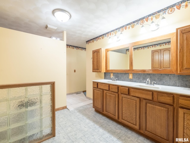 26620 Schuck Rd, Washington, IL 61571 - full bathroom with double vanity, backsplash, and baseboards