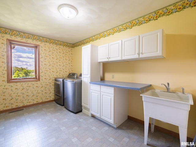 26620 Schuck Rd, Washington, IL 61571 - laundry area with washing machine and clothes dryer, cabinet space, baseboards, and wallpapered walls