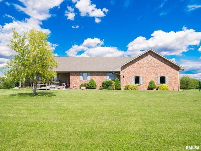 26620 Schuck Rd, Washington, IL 61571 - view of front facade featuring brick siding, a front yard, and a shingled roof