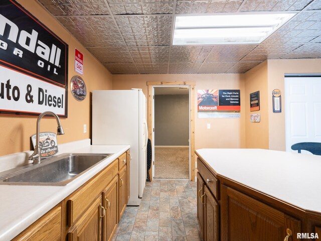 26620 Schuck Rd, Washington, IL 61571 - kitchen featuring a sink, freestanding refrigerator, light countertops, an ornate ceiling, and brown cabinetry