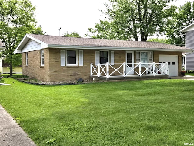 407 N 12th Ave, Canton, IL 61520 - view of front of property featuring covered porch, a garage, brick siding, and a front yard