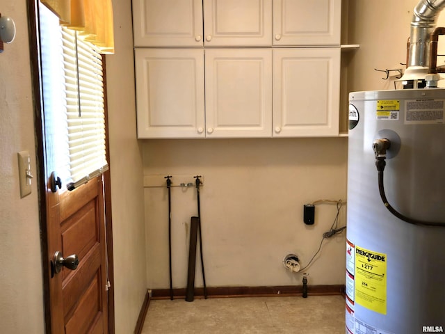 407 N 12th Ave, Canton, IL 61520 - laundry room featuring water heater, cabinet space, and baseboards