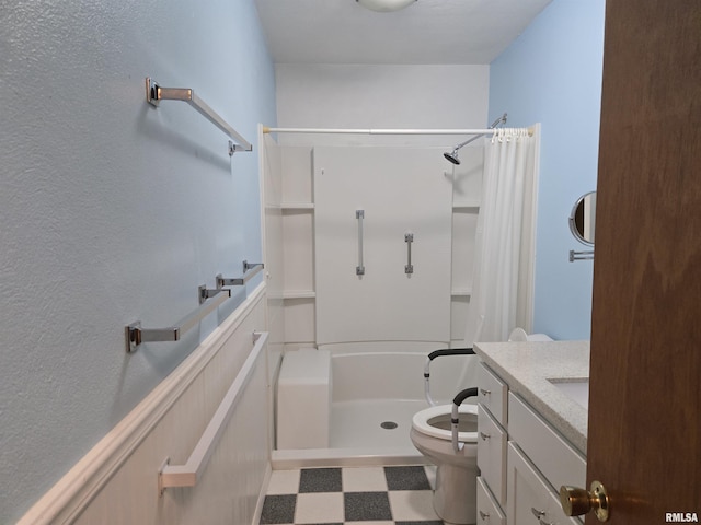 407 N 12th Ave, Canton, IL 61520 - bathroom with tile patterned floors, a shower with shower curtain, toilet, and vanity