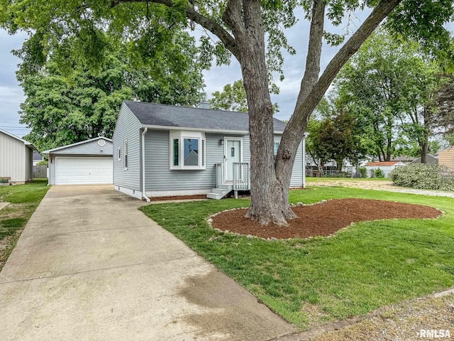 311 N 5th St, Chillicothe, IL 61523 - view of front facade featuring an outbuilding, a garage, a front lawn, a shingled roof, and a chimney