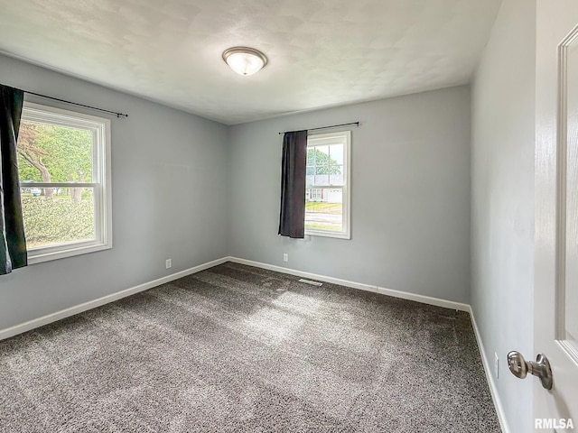 311 N 5th St, Chillicothe, IL 61523 - empty room with dark carpet and baseboards