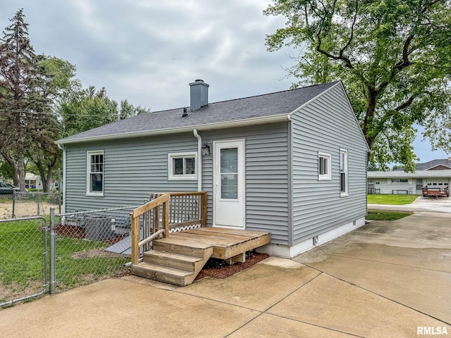 311 N 5th St, Chillicothe, IL 61523 - back of house featuring a chimney, crawl space, a patio area, and a shingled roof