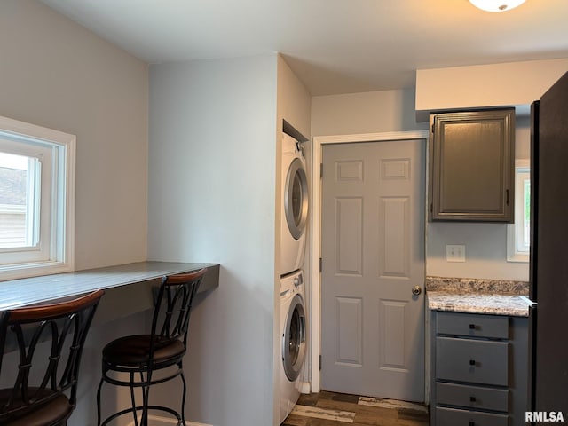 311 N 5th St, Chillicothe, IL 61523 - washroom with estacked washer and dryer, dark wood finished floors, and baseboards