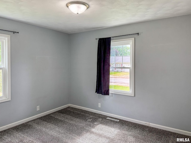 311 N 5th St, Chillicothe, IL 61523 - empty room featuring dark colored carpet and baseboards