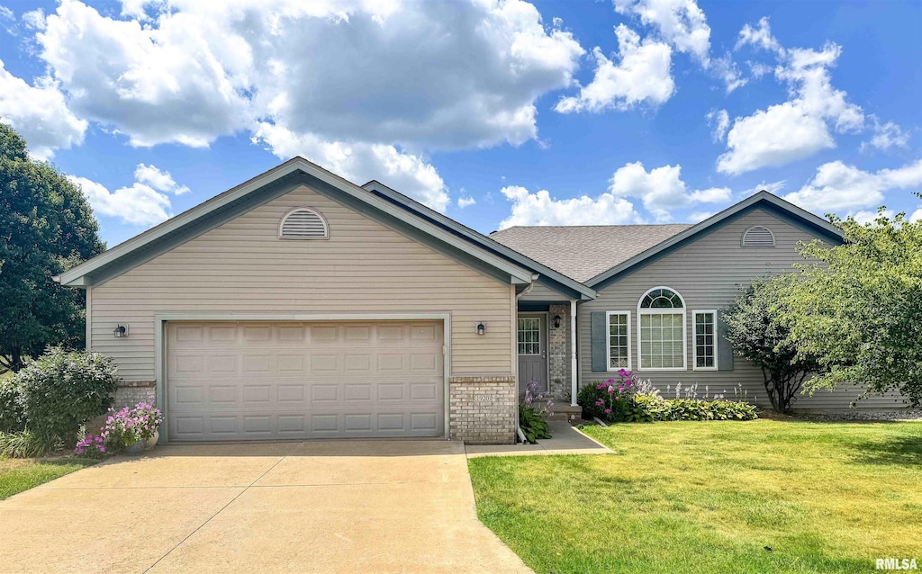 1920 W Jubilee Ln, Dunlap, IL 61525 - ranch-style home with brick siding, concrete driveway, an attached garage, and a front yard