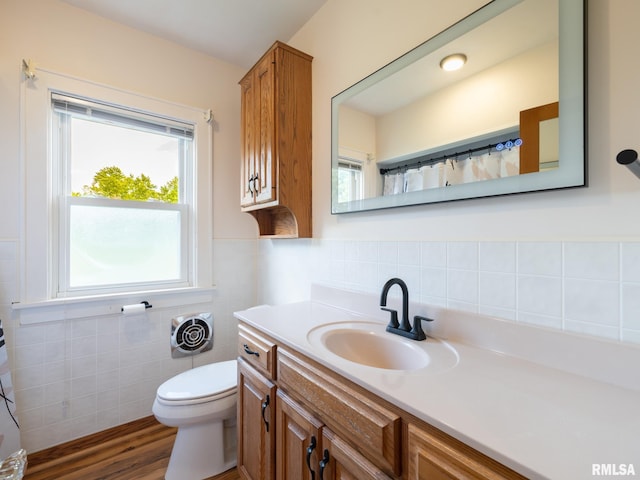 110 Loren St, Washington, IL 61571 - bathroom featuring vanity, toilet, tile walls, wood finished floors, and wainscoting
