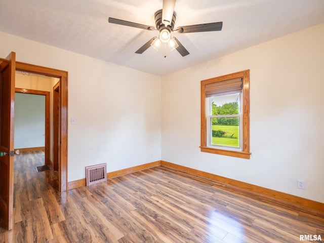 110 Loren St, Washington, IL 61571 - unfurnished room with wood finished floors, a ceiling fan, and baseboards