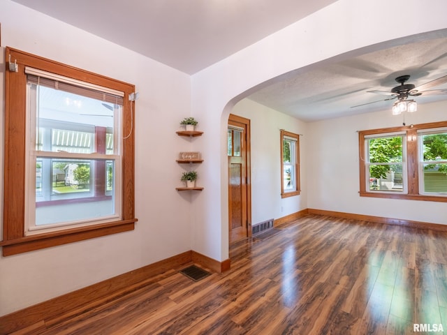 110 Loren St, Washington, IL 61571 - unfurnished room with arched walkways, healthy amount of natural light, and wood finished floors