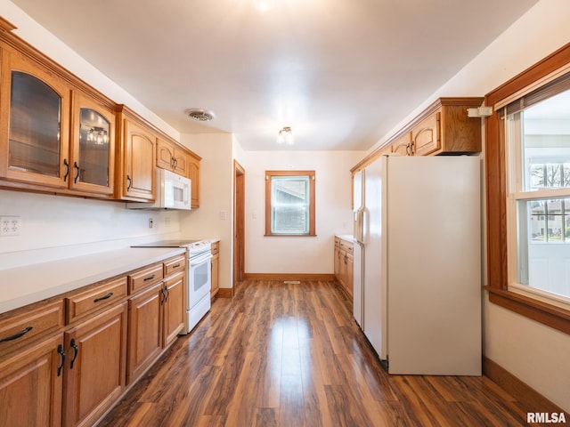 110 Loren St, Washington, IL 61571 - kitchen featuring white appliances, glass insert cabinets, dark wood-type flooring, light countertops, and brown cabinets