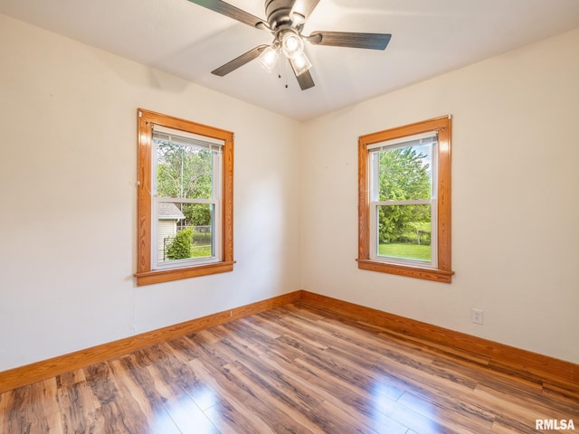 110 Loren St, Washington, IL 61571 - empty room featuring plenty of natural light, baseboards, and wood finished floors