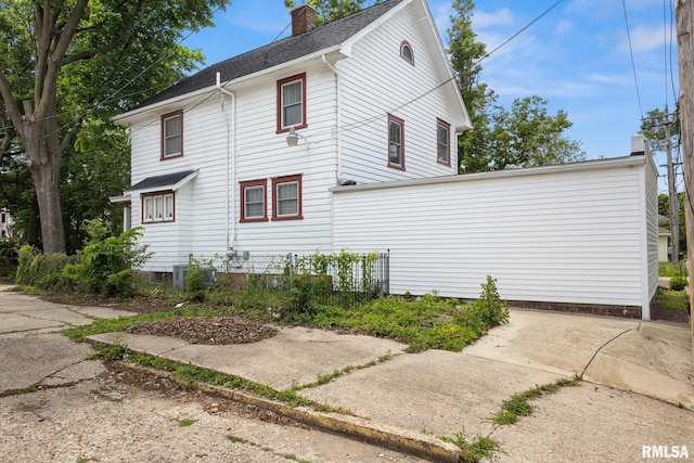 1006 N Maplewood Ave, Peoria, IL 61606 - view of home's exterior with a chimney and central AC unit