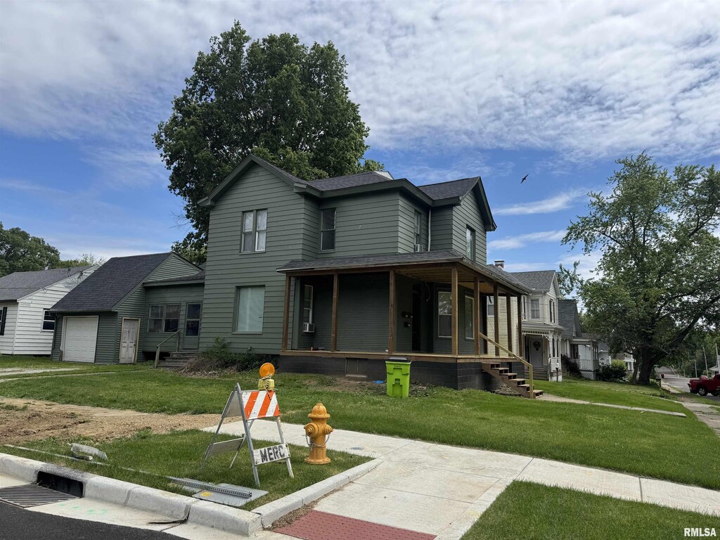 201 S Elm St, Washington, IL 61571 - view of front facade featuring a porch, a front lawn, a garage, and roof with shingles