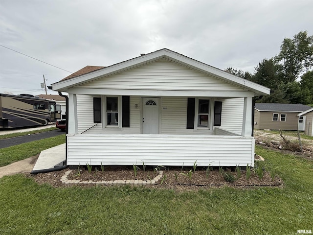 210 Minch St, South Pekin, IL 61564 - view of front of home with covered porch and a front lawn
