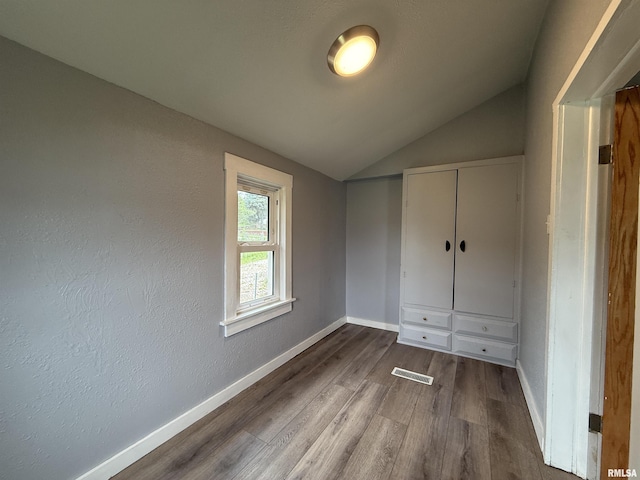 210 Minch St, South Pekin, IL 61564 - unfurnished bedroom with lofted ceiling, wood finished floors, baseboards, and a closet