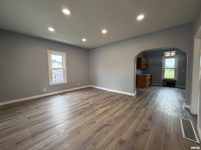 210 Minch St, South Pekin, IL 61564 - empty room with arched walkways, dark wood-type flooring, baseboards, and recessed lighting