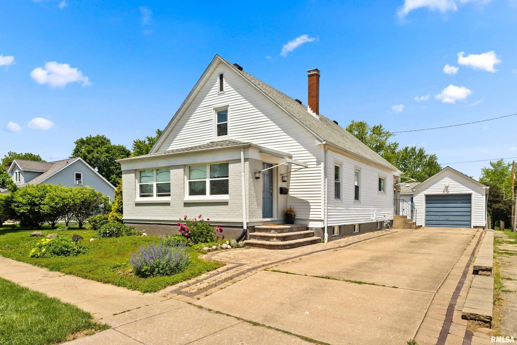 411 E Jefferson St, Washington, IL 61571 - view of front of house with an outbuilding, a chimney, a garage, concrete driveway, and a front yard