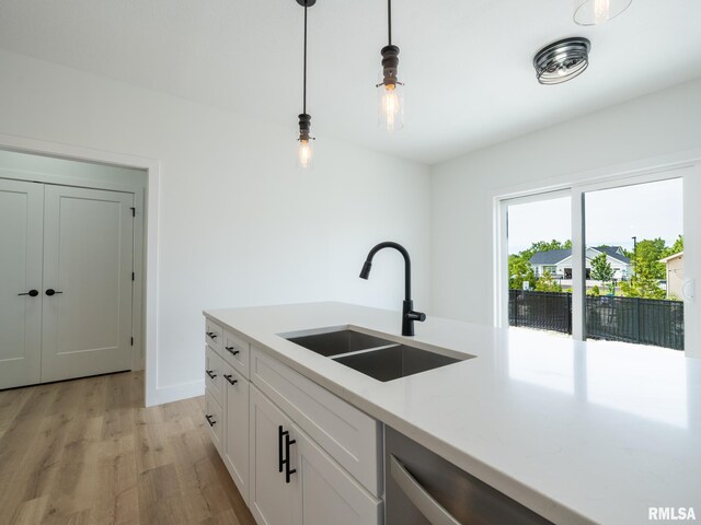 112 Shannon Hills Dr, Washington, IL 61571 - kitchen featuring a sink, light wood-style floors, decorative light fixtures, light countertops, and white cabinets