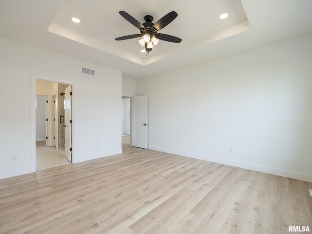 112 Shannon Hills Dr, Washington, IL 61571 - unfurnished bedroom featuring a raised ceiling, recessed lighting, light wood-style floors, and baseboards