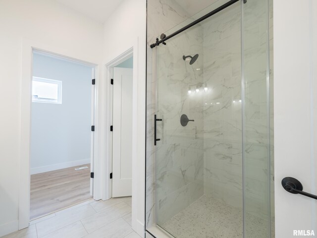 112 Shannon Hills Dr, Washington, IL 61571 - full bath with a marble finish shower, baseboards, and tile patterned floors