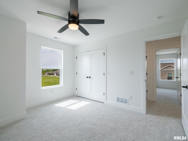112 Shannon Hills Dr, Washington, IL 61571 - unfurnished bedroom featuring carpet flooring, baseboards, a ceiling fan, and a closet