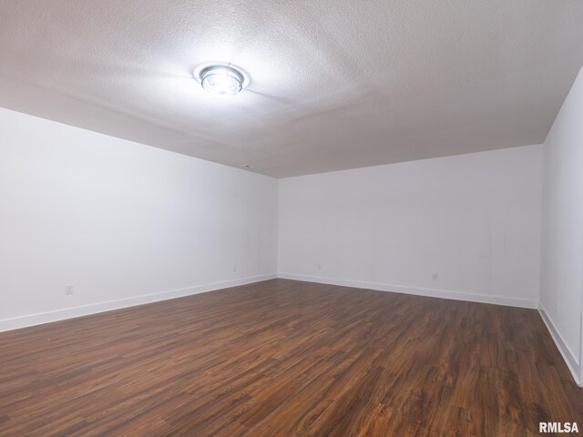 112 Shannon Hills Dr, Washington, IL 61571 - bonus room featuring dark wood finished floors, baseboards, and a textured ceiling