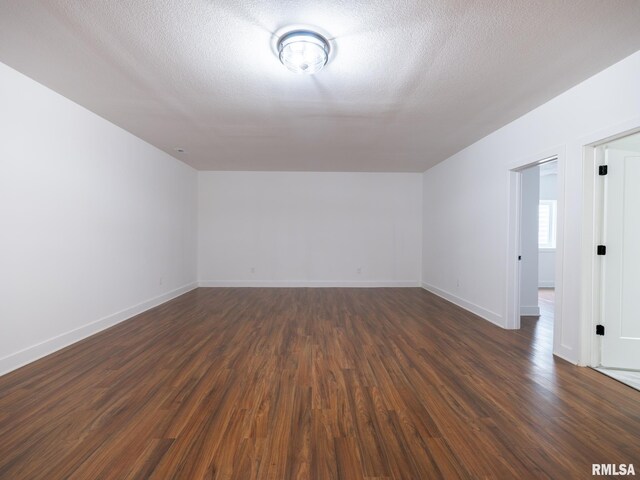 112 Shannon Hills Dr, Washington, IL 61571 - bonus room featuring dark wood finished floors, baseboards, and a textured ceiling