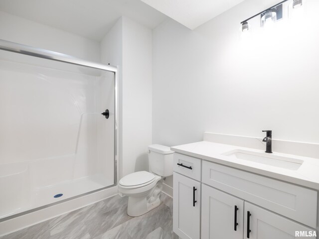 112 Shannon Hills Dr, Washington, IL 61571 - full bath with vanity, toilet, a stall shower, and baseboards