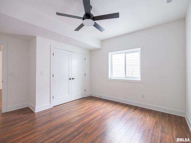 112 Shannon Hills Dr, Washington, IL 61571 - unfurnished bedroom with baseboards, dark wood finished floors, a closet, and a ceiling fan