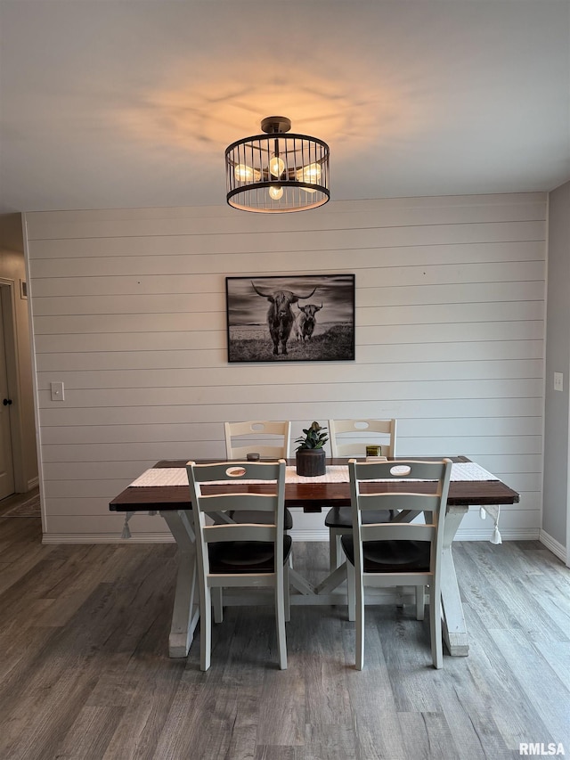 4170 E 1200th St, Macomb, IL 61455 - dining area with wood finished floors, a chandelier, baseboards, and wood walls