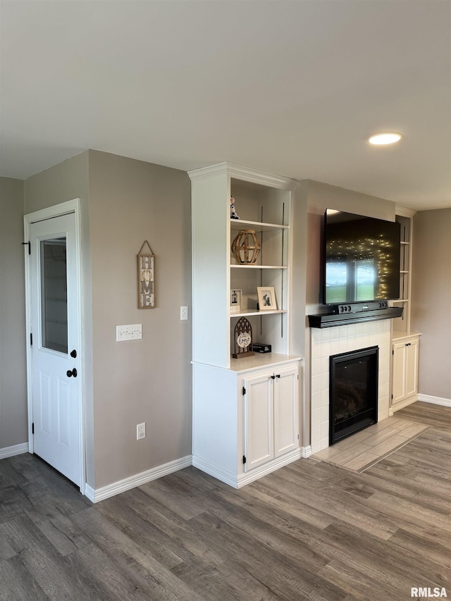 4170 E 1200th St, Macomb, IL 61455 - unfurnished living room with wood finished floors, a fireplace, and baseboards