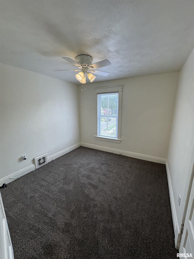 60 E Ash St, Canton, IL 61520 - empty room featuring dark carpet, a ceiling fan, and a textured ceiling